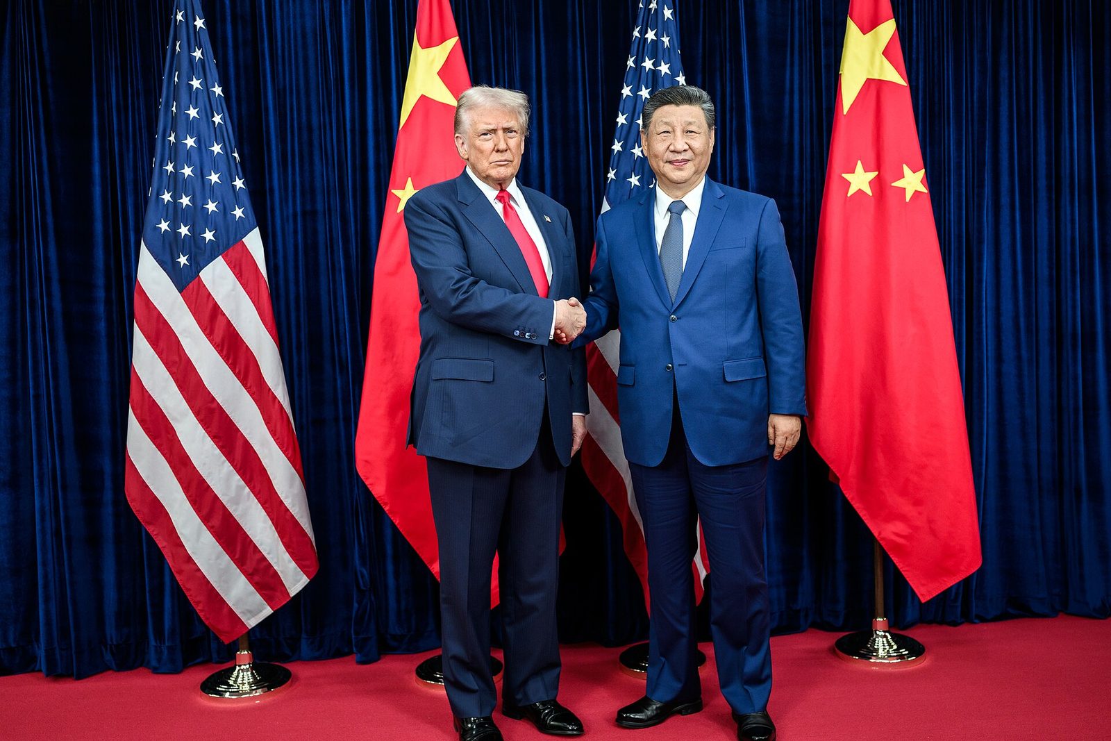 President Donald Trump greets President Xi Jinping before their meeting at Gimhae International Airport, Busan, 30 October 2025, where the trade truce was agreed. Photo: The White House / Wikimedia Commons.jpg), public domain.