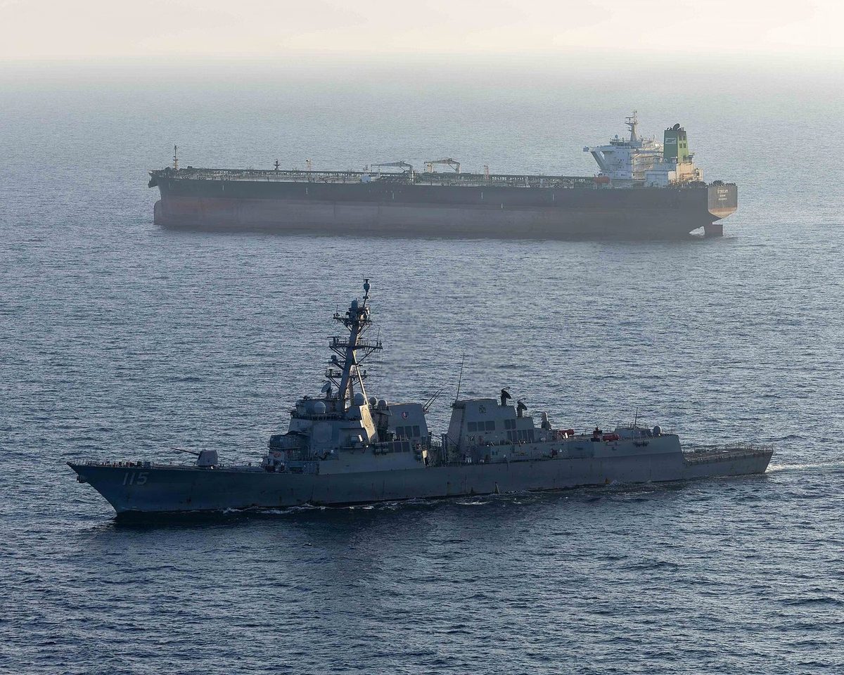 USS Rafael Peralta enforces the US maritime blockade against an Iranian-flagged ship heading for an Iranian port, April 2026. U.S. Navy photo via Wikimedia Commons, public domain.
